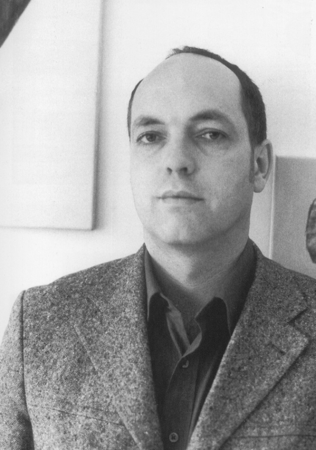 It shows the artist Dag Seemann in his studio looking at the camera.